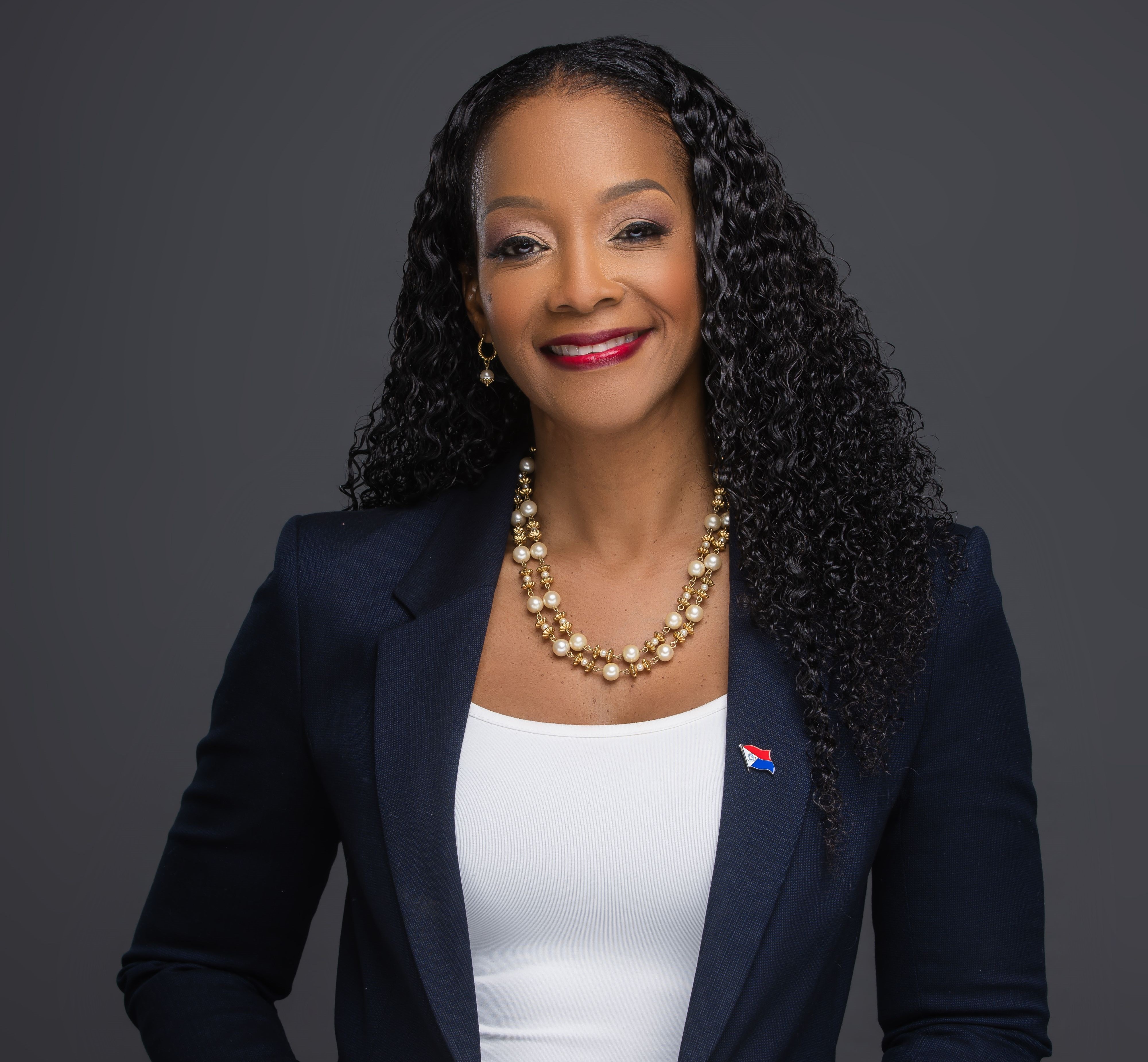 Angelique Romou smiling in a navy jacket