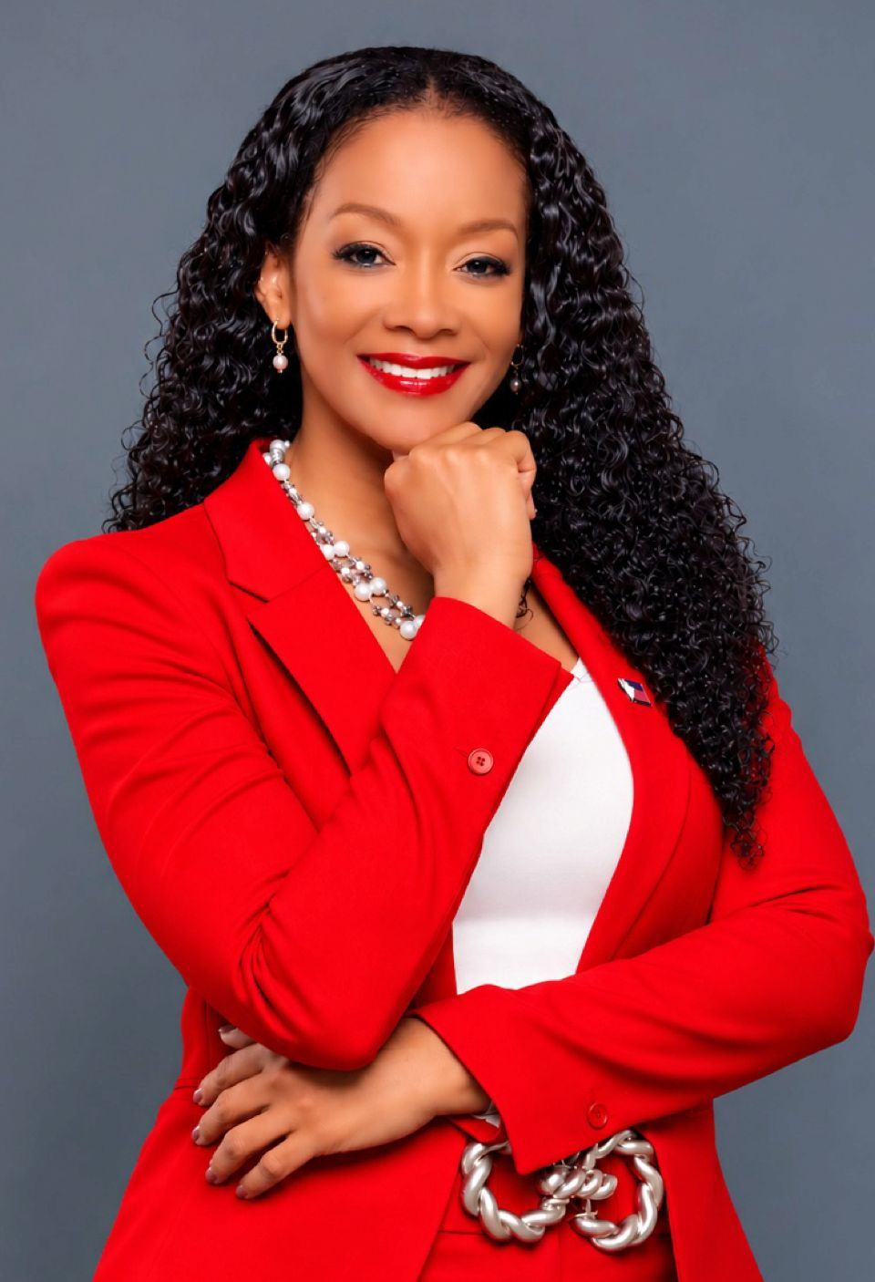 Angelique Romou, author of Saint Martin, I Love You, in a red suit
