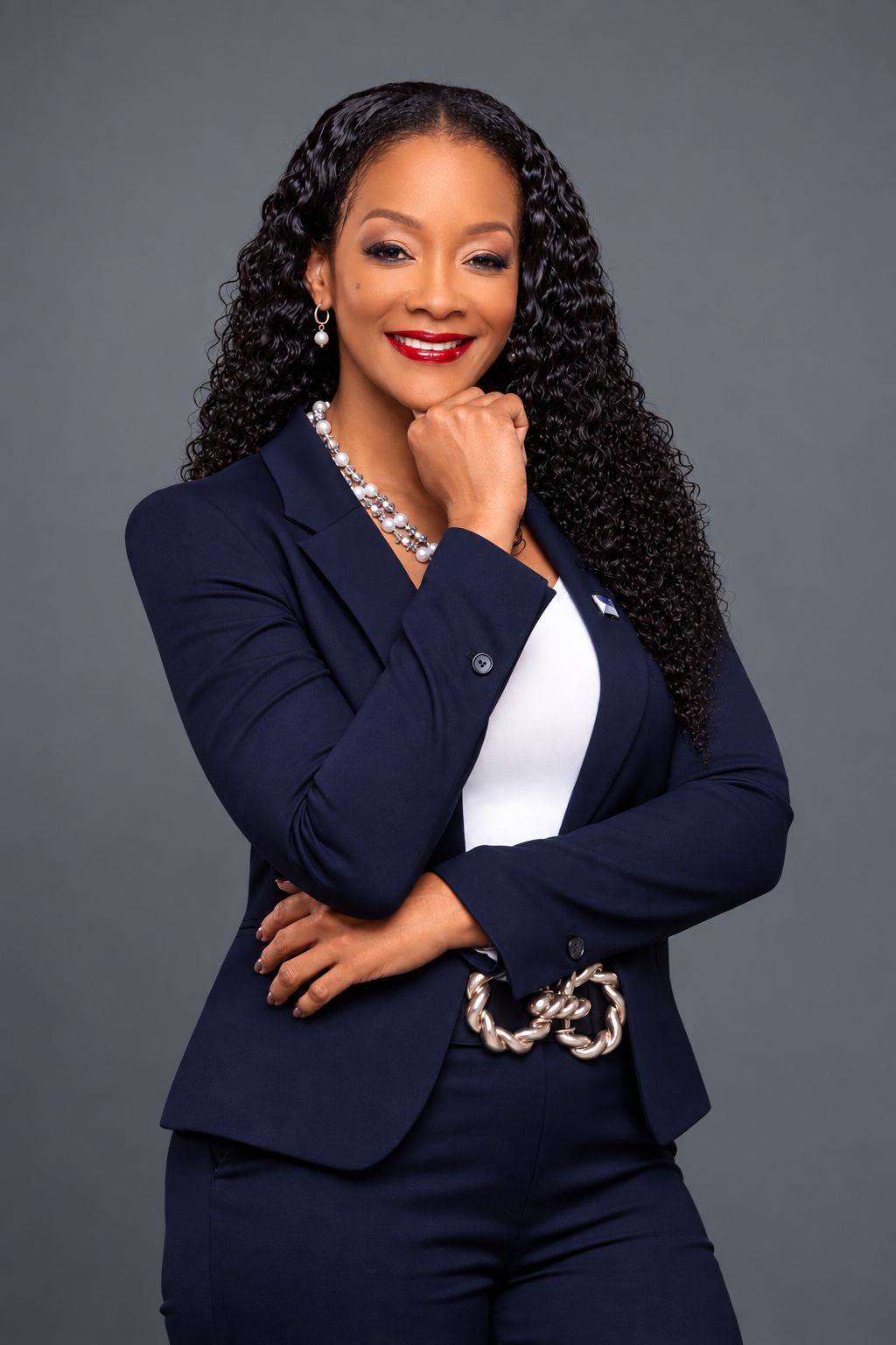 Angelique Romou smiling with her hand beneath her chin